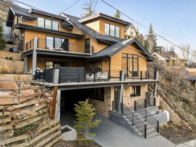 88 King Rd, Park City, UT 84060 - view of front of house featuring a shingled roof, concrete driveway, central AC, and a balcony