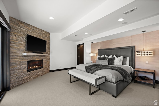 88 King Rd, Park City, UT 84060 - bedroom featuring visible vents, an accent wall, baseboards, light colored carpet, and a large fireplace