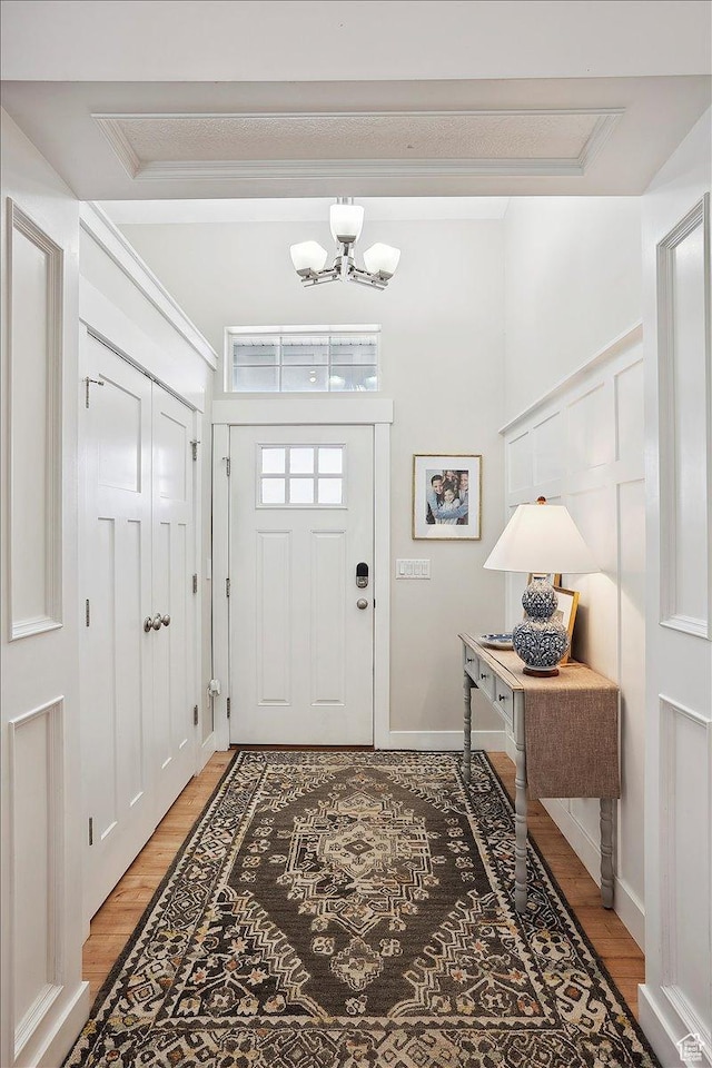 1380 Angel Crest Way, Kaysville, UT 84037 - foyer entrance featuring ornamental molding, light wood finished floors, and a notable chandelier