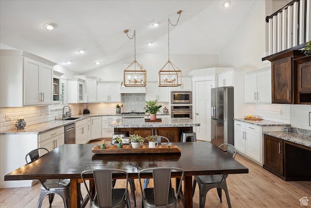 1380 Angel Crest Way, Kaysville, UT 84037 - kitchen with white cabinets, a sink, appliances with stainless steel finishes, a kitchen island, and backsplash