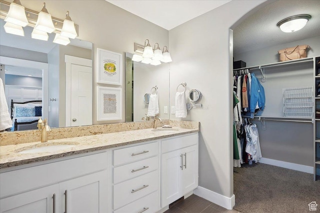 1380 Angel Crest Way, Kaysville, UT 84037 - full bathroom with baseboards, a walk in closet, double vanity, and a sink