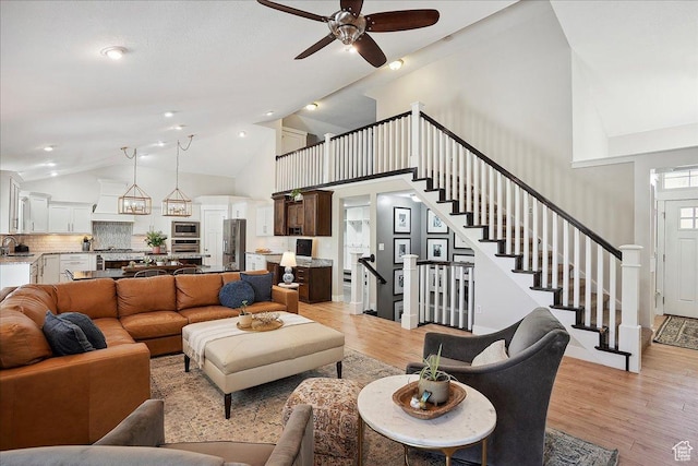 1380 Angel Crest Way, Kaysville, UT 84037 - living room featuring lofted ceiling, ceiling fan, light wood-type flooring, and stairs