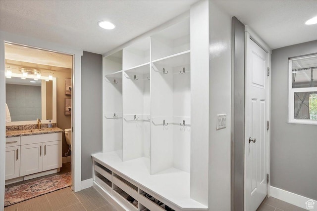 1380 Angel Crest Way, Kaysville, UT 84037 - mudroom with recessed lighting, a sink, and baseboards