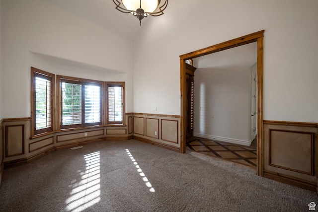 10252 S 3570 W, South Jordan, UT 84095 - empty room with wainscoting, carpet floors, a decorative wall, and vaulted ceiling