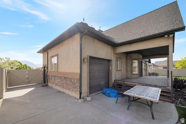 10252 S 3570 W, South Jordan, UT 84095 - view of home's exterior with a garage, stone siding, stucco siding, and a gate