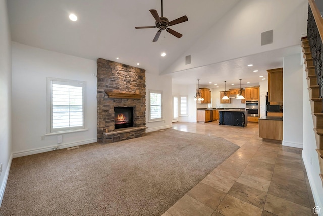 10252 S 3570 W, South Jordan, UT 84095 - unfurnished living room with ceiling fan, baseboards, recessed lighting, high vaulted ceiling, and a stone fireplace