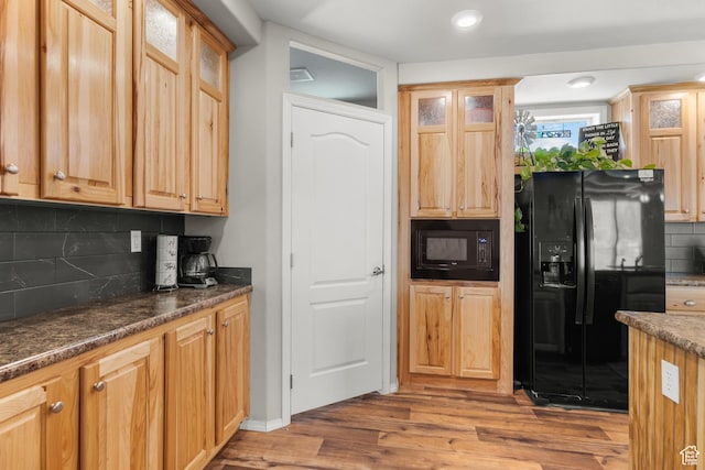 4147 S Spanish Valley Dr, Moab, UT 84532 - kitchen with black appliances, wood finished floors, tasteful backsplash, and glass insert cabinets