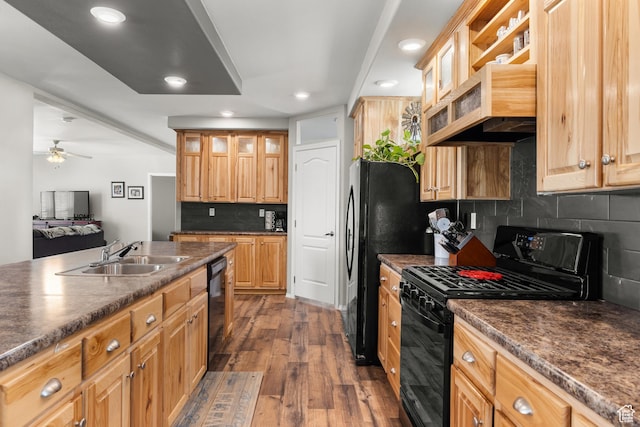 4147 S Spanish Valley Dr, Moab, UT 84532 - kitchen featuring dark wood finished floors, decorative backsplash, black appliances, dark countertops, and a sink