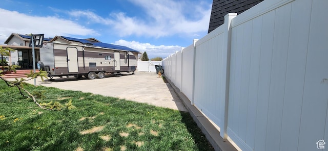 4616 S 3720 W, West Valley City, UT 84120 - view of property exterior with an outdoor structure, a fenced backyard, a shed, a patio area, and a lawn
