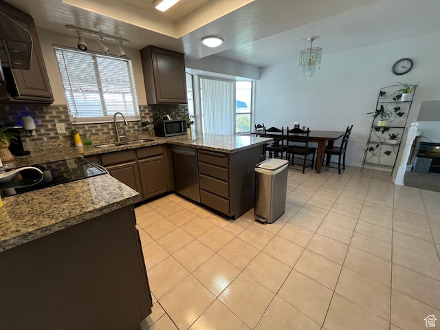 4616 S 3720 W, West Valley City, UT 84120 - kitchen with a peninsula, dishwashing machine, tasteful backsplash, a sink, and light tile patterned floors