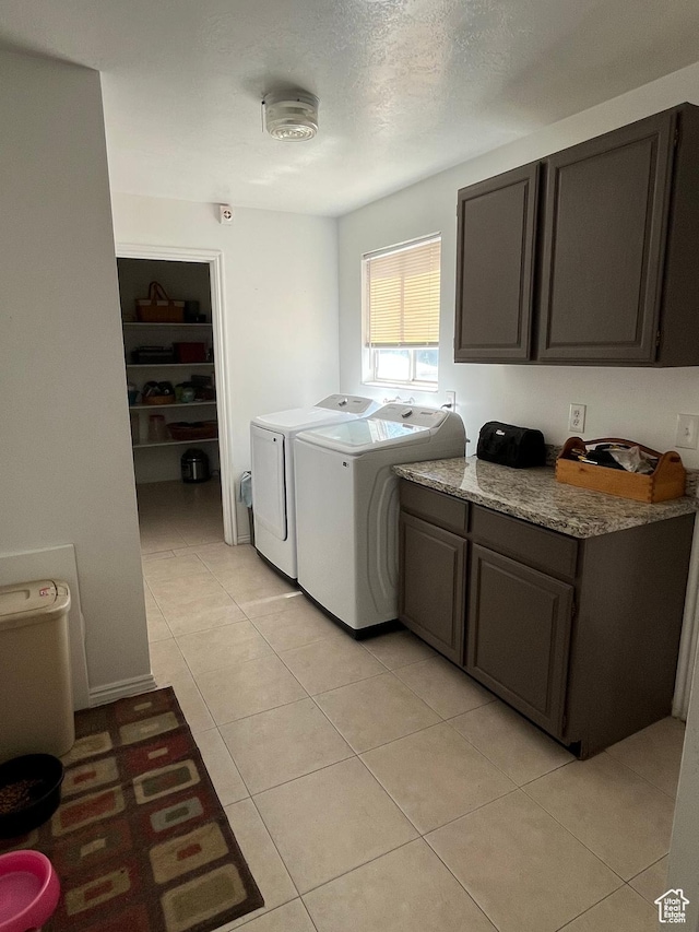 4616 S 3720 W, West Valley City, UT 84120 - laundry room with cabinet space, light tile patterned floors, and washer and clothes dryer