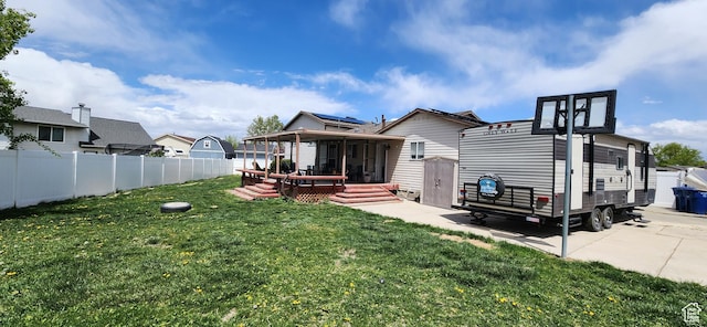 4616 S 3720 W, West Valley City, UT 84120 - rear view of house featuring a sunroom, a fenced backyard, a yard, and a deck