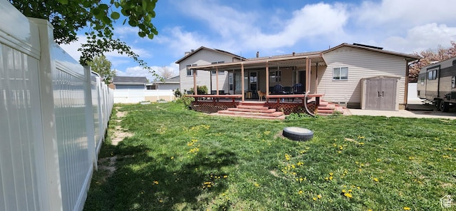 4616 S 3720 W, West Valley City, UT 84120 - back of property featuring a fenced backyard, a yard, and a deck