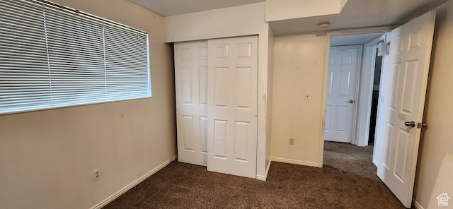 4616 S 3720 W, West Valley City, UT 84120 - unfurnished bedroom featuring baseboards, dark carpet, and a closet