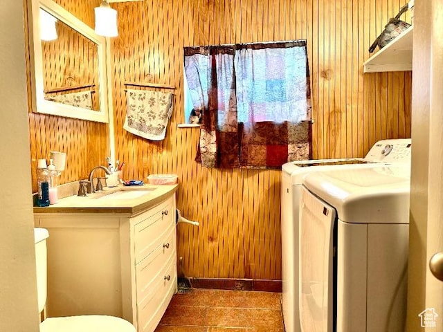 225 S 1400 W, Vernal, UT 84078 - clothes washing area featuring wooden walls, washing machine and clothes dryer, laundry area, and a sink