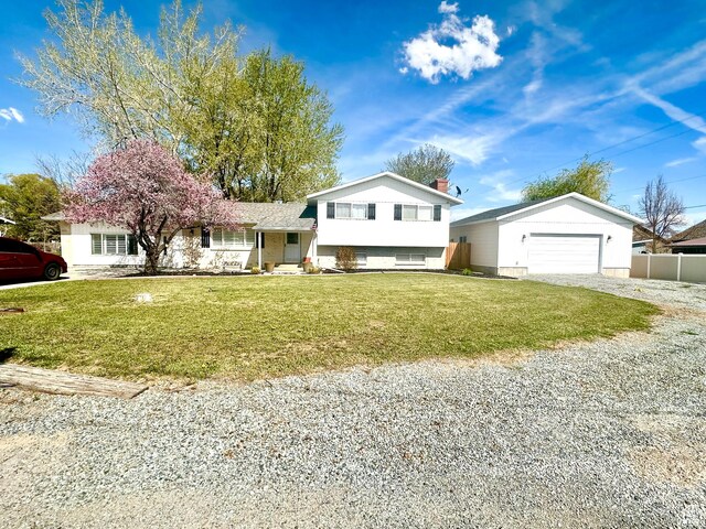 225 S 1400 W, Vernal, UT 84078 - tri-level home featuring a garage, fence, driveway, and a front yard