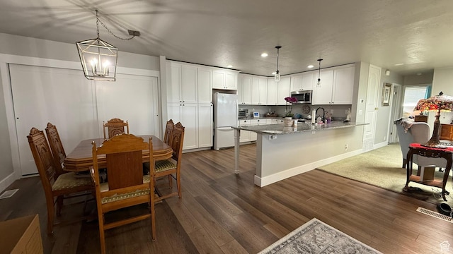379 W 400 N Unit 7, Bountiful, UT 84010 - kitchen with white cabinetry, stainless steel microwave, a sink, freestanding refrigerator, and a peninsula
