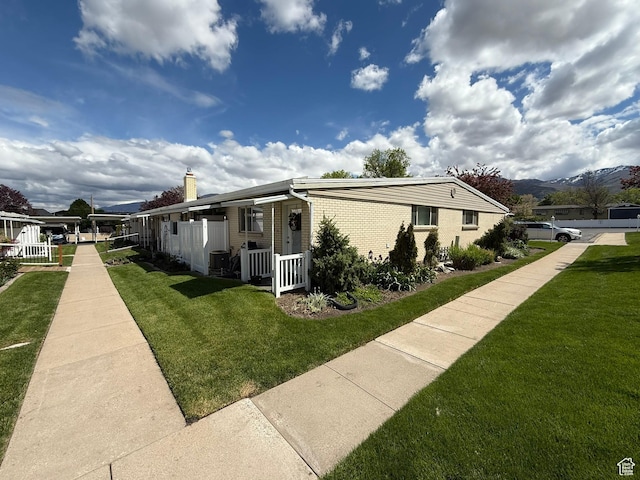 379 W 400 N Unit 7, Bountiful, UT 84010 - view of side of property with a chimney, a yard, and brick siding