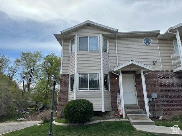 townhome / multi-family property with brick siding