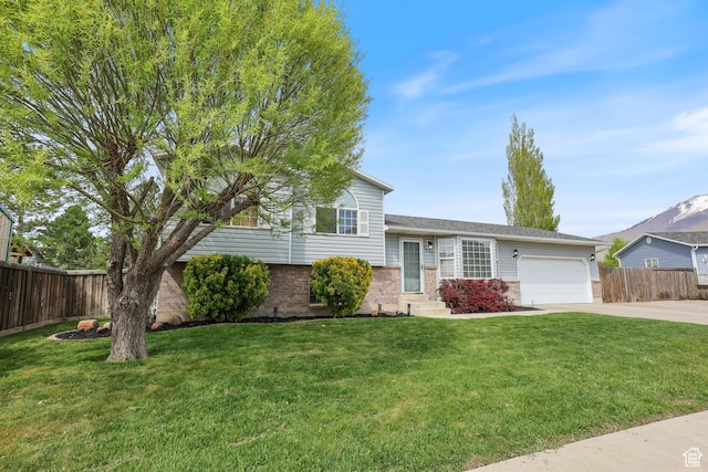 2627 E 1680 S, Spanish Fork, UT 84660 - split level home featuring a front yard, a garage, driveway, brick siding, and fence
