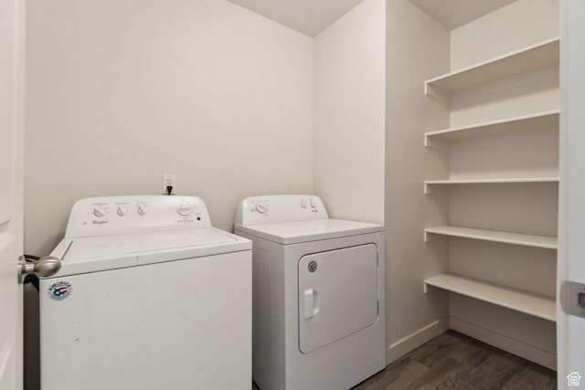 laundry area featuring laundry area, washer and clothes dryer, dark wood finished floors, and baseboards