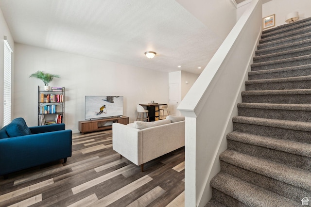 staircase featuring recessed lighting and wood finished floors