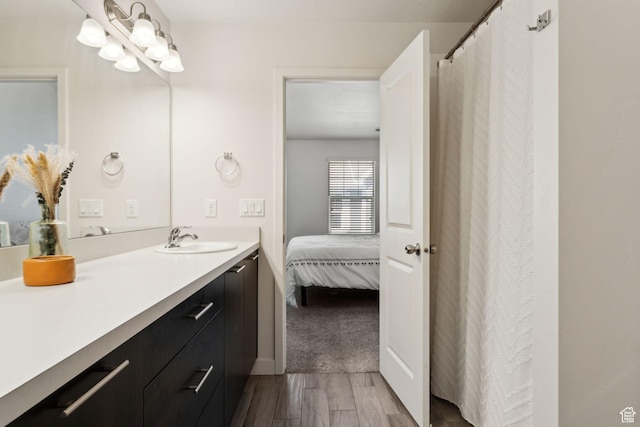 full bathroom featuring vanity, connected bathroom, and wood finished floors