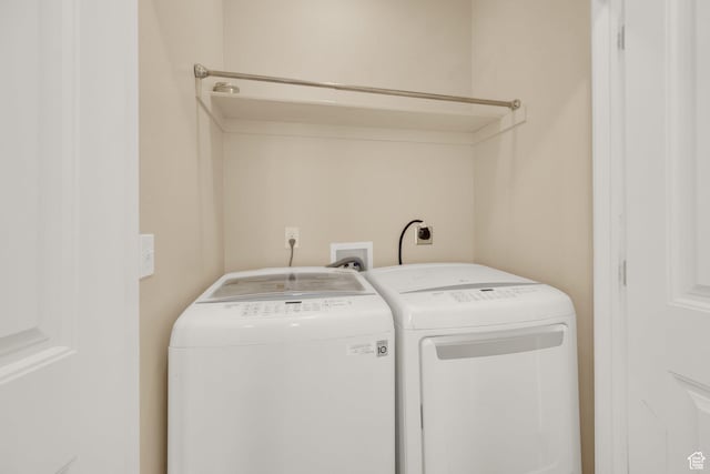 laundry area with washing machine and clothes dryer