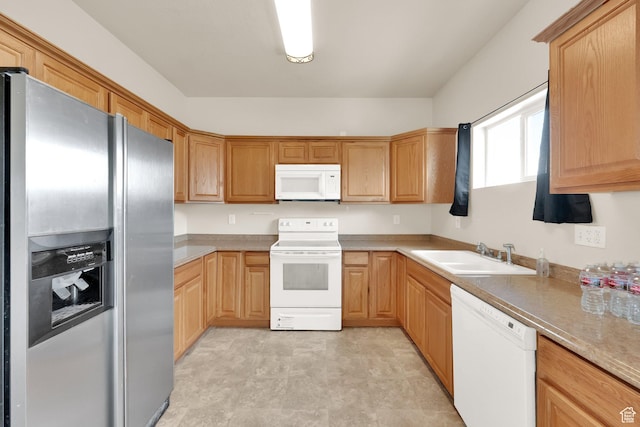 kitchen with white appliances, light countertops, and a sink