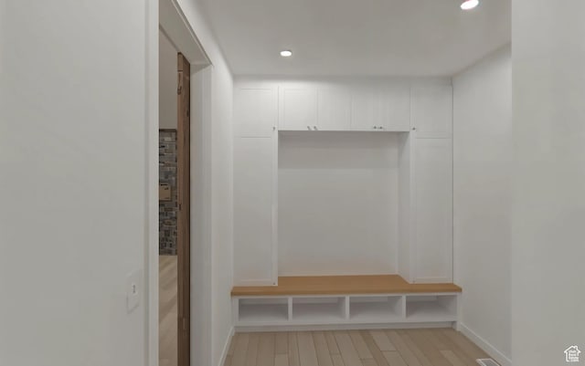 mudroom with recessed lighting, light wood-style flooring, and baseboards
