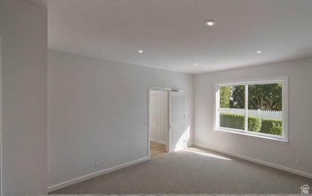 carpeted spare room with recessed lighting and baseboards
