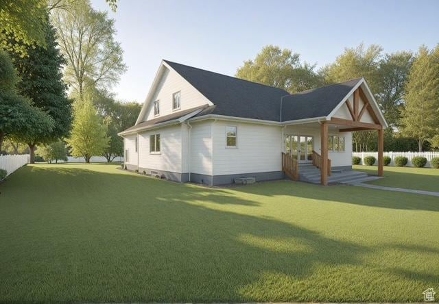 view of property exterior with a lawn, fence, and french doors