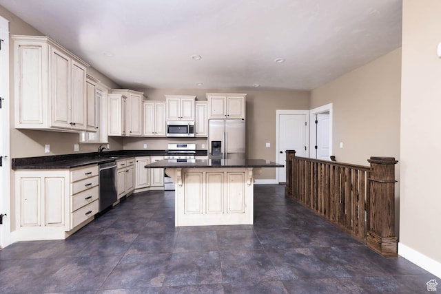 167 E 300 S, Salina, UT 84654 - kitchen with stainless steel appliances, a sink, baseboards, dark countertops, and recessed lighting