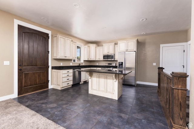 167 E 300 S, Salina, UT 84654 - kitchen with appliances with stainless steel finishes, baseboards, dark countertops, a kitchen breakfast bar, and recessed lighting