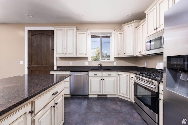 167 E 300 S, Salina, UT 84654 - kitchen with appliances with stainless steel finishes, a sink, recessed lighting, and dark stone countertops