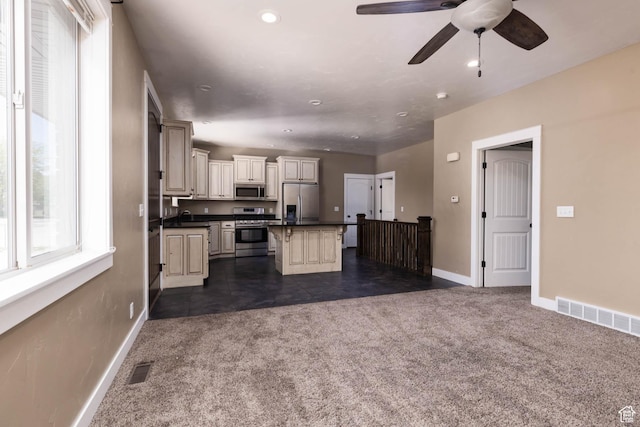167 E 300 S, Salina, UT 84654 - kitchen featuring stainless steel appliances, dark carpet, dark countertops, cream cabinetry, and baseboards