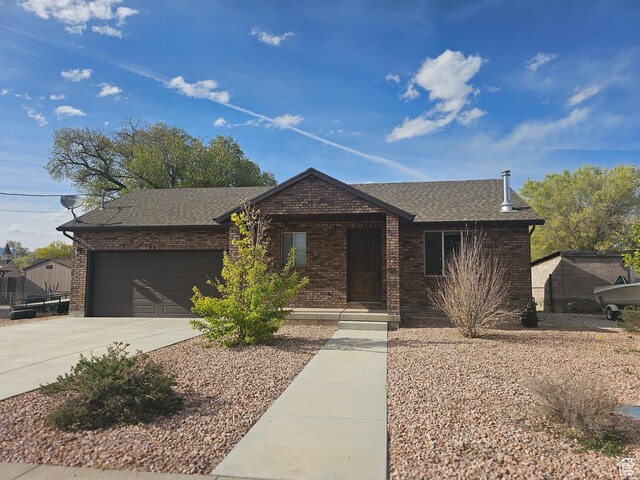 167 E 300 S, Salina, UT 84654 - ranch-style house featuring brick siding, a garage, driveway, and roof with shingles