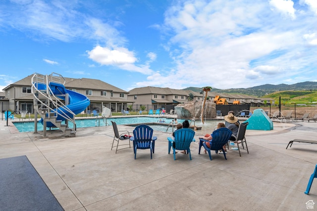 140 W 150 S Unit H29, Garden City, UT 84028 - pool featuring a residential view, a mountain view, a water slide, and fence