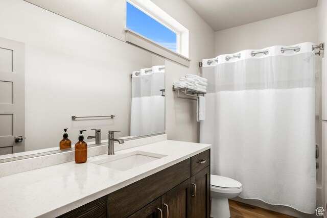 140 W 150 S Unit H29, Garden City, UT 84028 - full bathroom featuring shower / bath combo with shower curtain, wood finished floors, toilet, and vanity