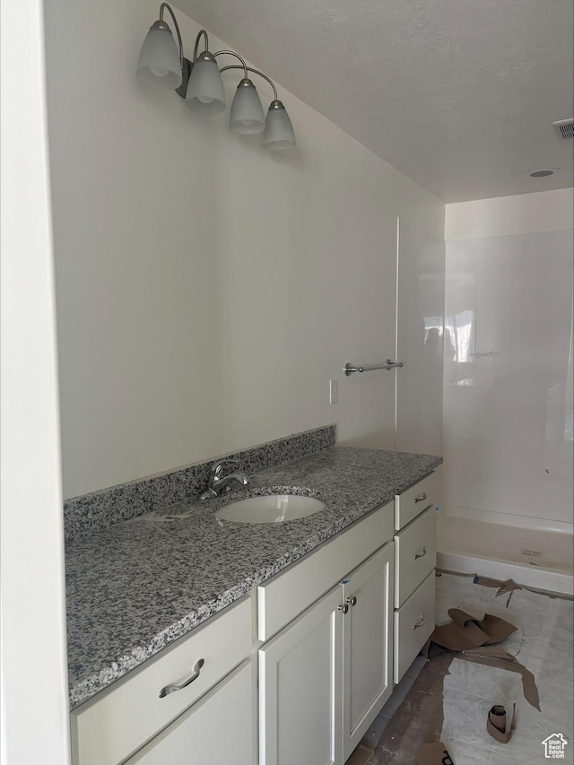 full bathroom with vanity and walk in shower