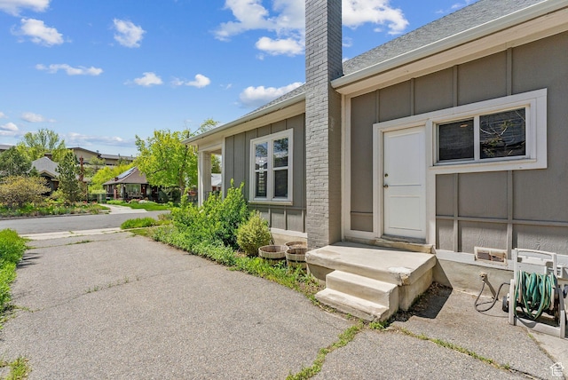 447 E Westminster Ave S, Salt Lake City, UT 84115 - property entrance with board and batten siding and a chimney