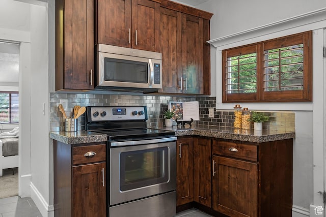 447 E Westminster Ave S, Salt Lake City, UT 84115 - kitchen featuring appliances with stainless steel finishes, decorative backsplash, dark countertops, and dark brown cabinetry