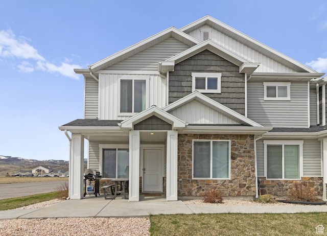 craftsman house with board and batten siding and stone siding