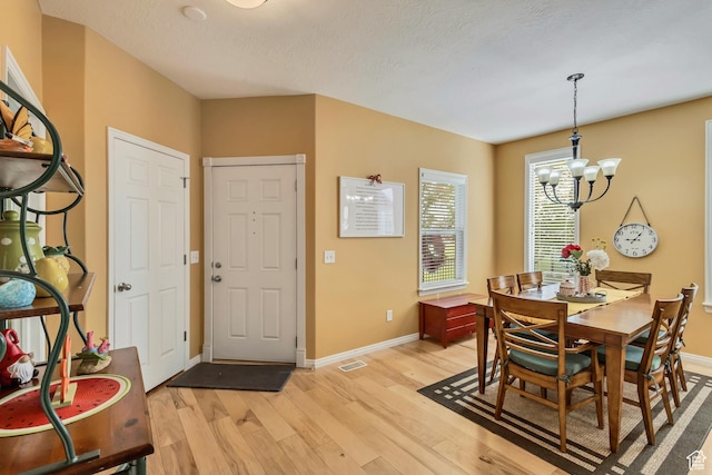 4352 W Degray Dr S, South Jordan, UT 84009 - dining space featuring visible vents, a notable chandelier, baseboards, and light wood-type flooring