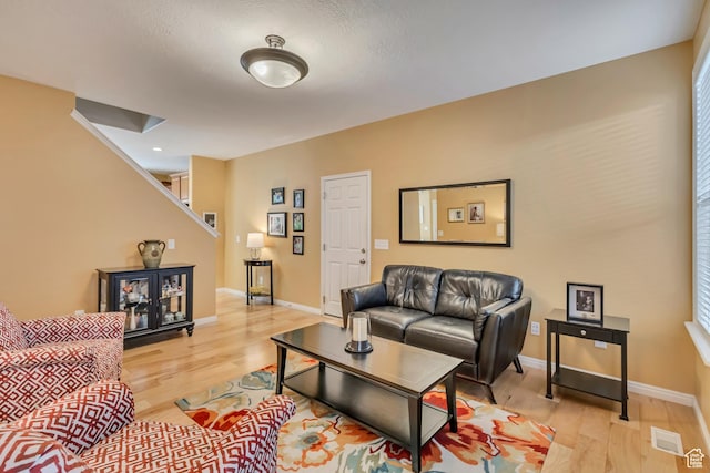 4352 W Degray Dr S, South Jordan, UT 84009 - living room with baseboards, visible vents, stairs, and light wood-style flooring