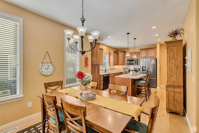 4352 W Degray Dr S, South Jordan, UT 84009 - dining space featuring an inviting chandelier, visible vents, light wood-type flooring, and baseboards