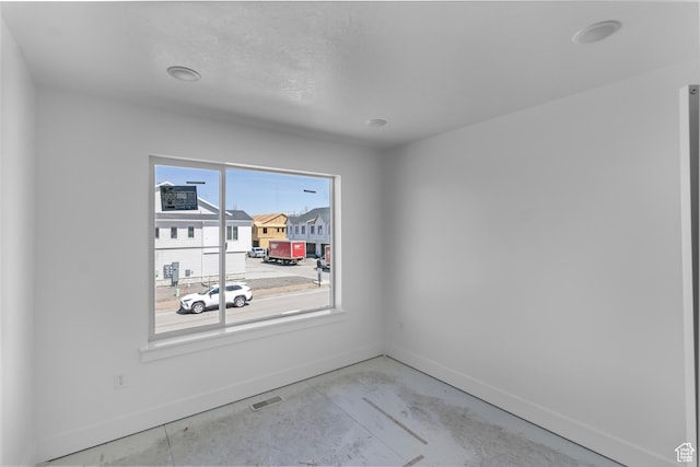 1232 W 575 S, Logan, UT 84321 - unfurnished room featuring concrete flooring, visible vents, and baseboards