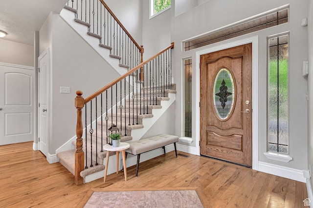 6861 S Triumph Ln, West Jordan, UT 84084 - entrance foyer with wood-type flooring, baseboards, and stairs