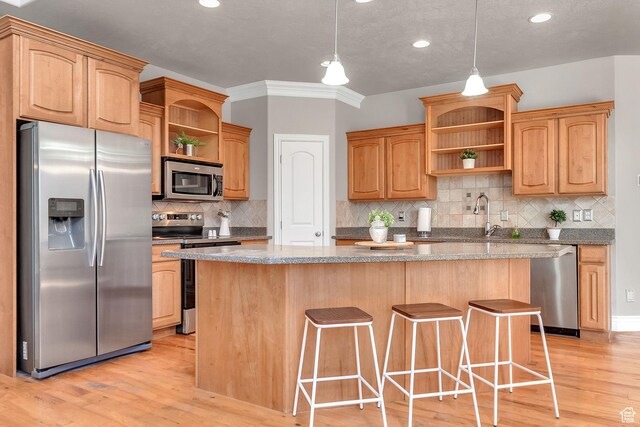 6861 S Triumph Ln, West Jordan, UT 84084 - kitchen with open shelves, appliances with stainless steel finishes, light wood finished floors, a center island, and recessed lighting