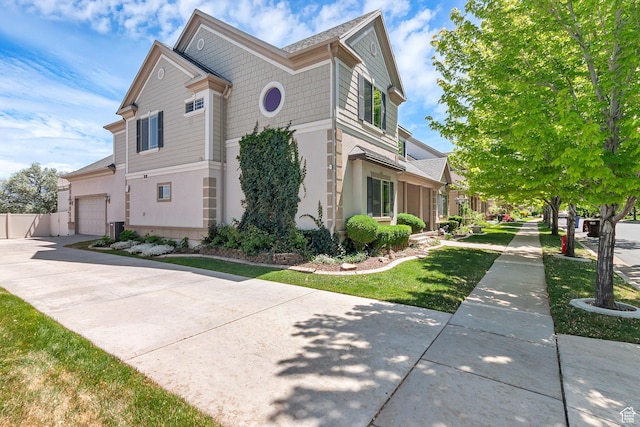6861 S Triumph Ln, West Jordan, UT 84084 - view of property exterior with an attached garage, driveway, and stucco siding